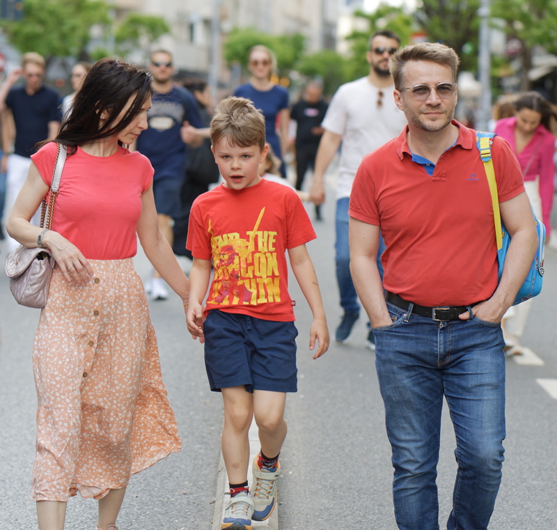 Family walking down a street in Bucharest